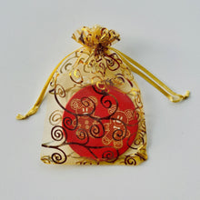 Load image into Gallery viewer, Gold organza bag with ornament inside