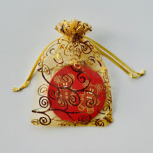 Load image into Gallery viewer, Gold organza bag with ornament inside